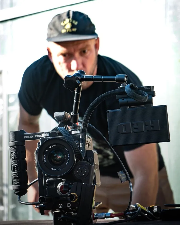 Jaron operating a camera on set